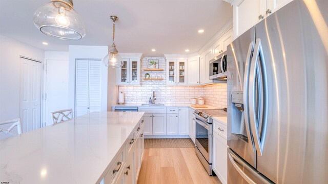 111 S 16th Ave Unit 510, Longport, NJ 08403 - kitchen featuring stainless steel appliances, a sink, white cabinetry, decorative backsplash, and recessed lighting