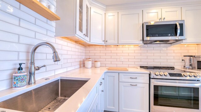 111 S 16th Ave Unit 510, Longport, NJ 08403 - kitchen with appliances with stainless steel finishes, a sink, white cabinets, and tasteful backsplash