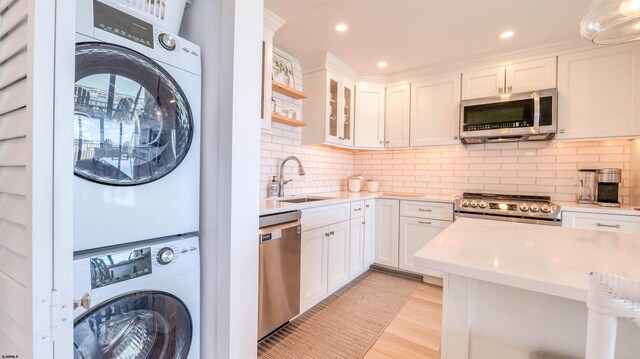 111 S 16th Ave Unit 510, Longport, NJ 08403 - laundry room featuring stacked washer and clothes dryer, light wood-style flooring, and recessed lighting