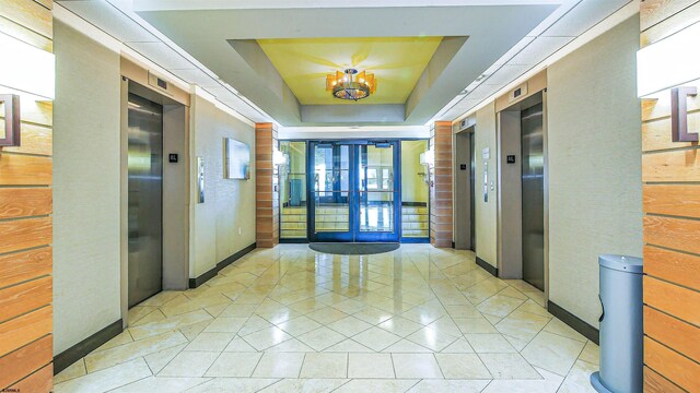 111 S 16th Ave Unit 510, Longport, NJ 08403 - entryway featuring light tile patterned floors, elevator, a raised ceiling, and a chandelier