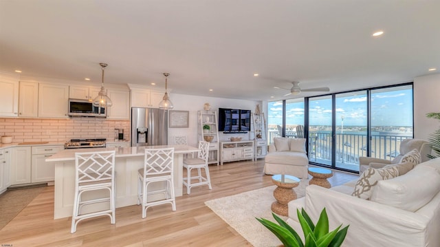 111 S 16th Ave Unit 510, Longport, NJ 08403 - living room featuring expansive windows, recessed lighting, light wood-style floors, and ceiling fan