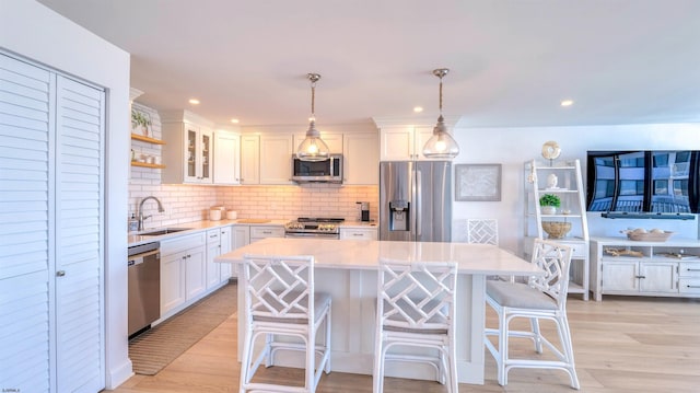 111 S 16th Ave Unit 510, Longport, NJ 08403 - kitchen featuring appliances with stainless steel finishes, a sink, a kitchen island, white cabinetry, and light countertops