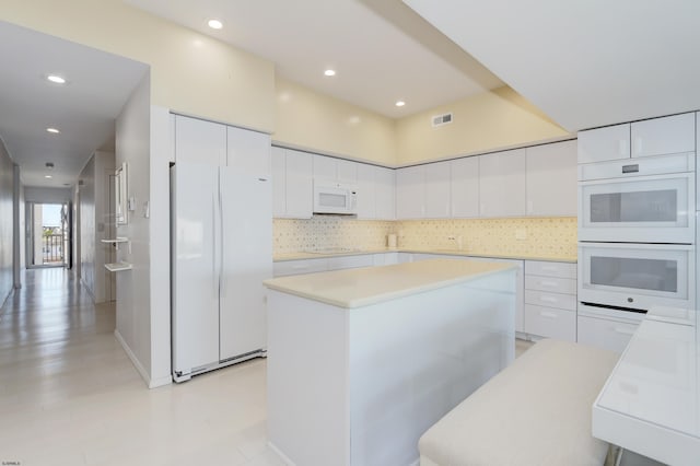 3007 Bayshore Ave Unit 23, Brigantine, NJ 08203 - kitchen featuring white appliances, white cabinets, modern cabinets, light countertops, and a center island