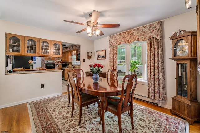801 New York Ave, Absecon, NJ 08201 - dining area featuring a baseboard heating unit, light wood finished floors, and a ceiling fan