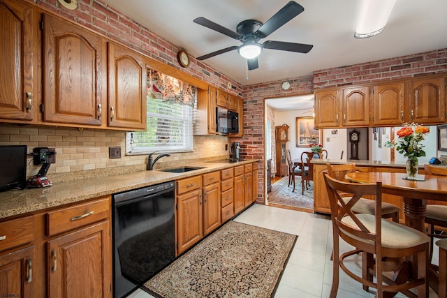 801 New York Ave, Absecon, NJ 08201 - kitchen with black appliances, a sink, brick wall, and brown cabinetry
