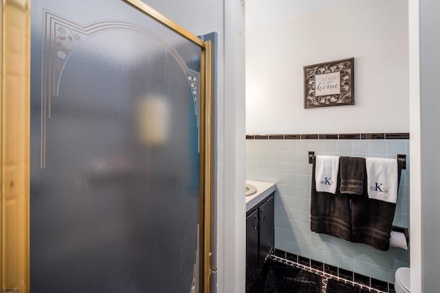 801 New York Ave, Absecon, NJ 08201 - bathroom with toilet, tile walls, vanity, a wainscoted wall, and tile patterned floors