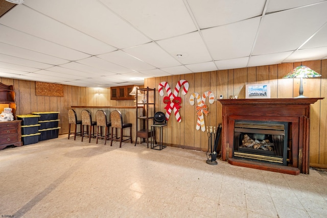 801 New York Ave, Absecon, NJ 08201 - interior space with wooden walls, tile patterned floors, a drop ceiling, baseboards, and a glass covered fireplace