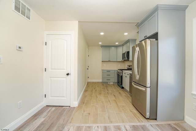 1013 New Rd, Northfield, NJ 08225 - kitchen featuring stainless steel appliances, gray cabinetry, light wood finished floors, backsplash, and recessed lighting