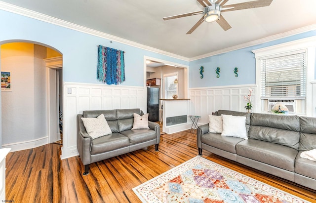 5003 Atlantic Ave Unit C04, Ventnor, NJ 08406 - living area featuring arched walkways, ceiling fan, wood finished floors, ornamental molding, and a wainscoted wall