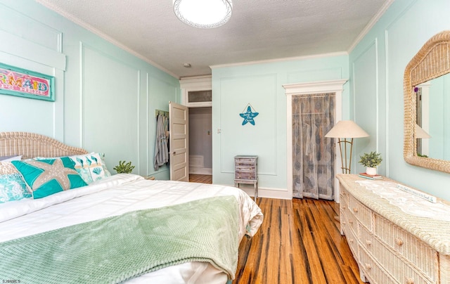5003 Atlantic Ave Unit C04, Ventnor, NJ 08406 - bedroom with ornamental molding, a decorative wall, wood finished floors, and a textured ceiling