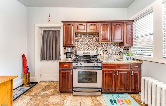 5003 Atlantic Ave Unit C04, Ventnor, NJ 08406 - kitchen with radiator heating unit, gas stove, a sink, backsplash, and baseboards