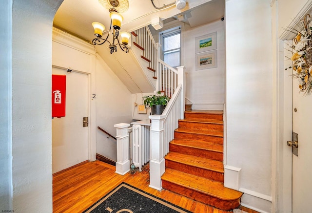 5003 Atlantic Ave Unit C04, Ventnor, NJ 08406 - stairway featuring wood finished floors, a chandelier, and arched walkways