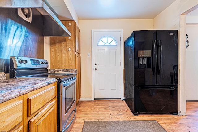 304 N Annapolis Ave, Atlantic City, NJ 08401 - kitchen with black fridge with ice dispenser, stainless steel electric stove, light wood finished floors, and brown cabinets
