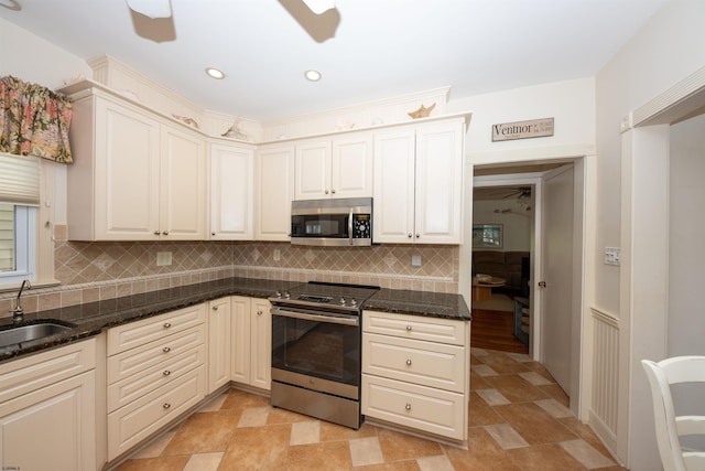 14 N Cambridge Ave, Ventnor, NJ 08406 - kitchen with appliances with stainless steel finishes, tasteful backsplash, a sink, dark stone counters, and recessed lighting