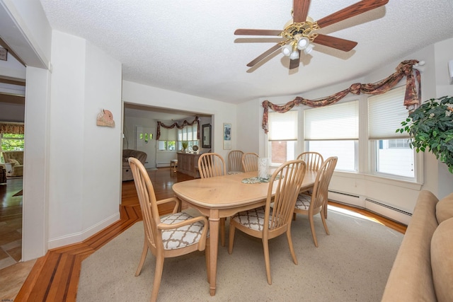 14 N Cambridge Ave, Ventnor, NJ 08406 - dining area with light wood finished floors, a baseboard heating unit, ceiling fan, and a textured ceiling
