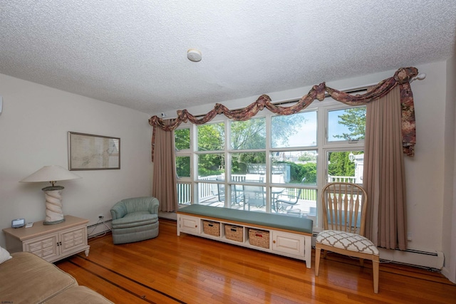 14 N Cambridge Ave, Ventnor, NJ 08406 - living room with baseboard heating, plenty of natural light, a textured ceiling, and light wood-type flooring