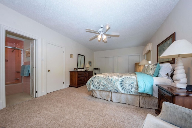 14 N Cambridge Ave, Ventnor, NJ 08406 - carpeted bedroom featuring two closets, ensuite bathroom, a textured ceiling, and a ceiling fan
