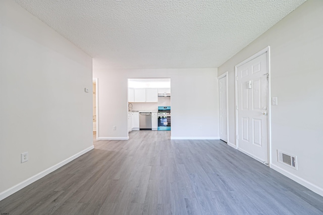 161 Sussex Pl Unit 161, Galloway Township, NJ 08205 - unfurnished living room featuring wood finished floors, baseboards, a textured ceiling, and a sink