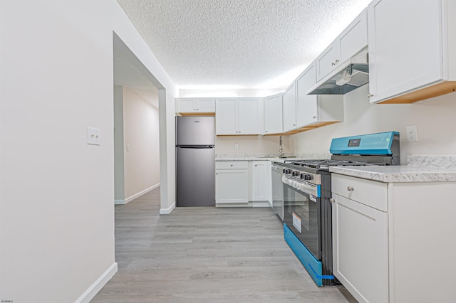 161 Sussex Pl Unit 161, Galloway Township, NJ 08205 - kitchen with stainless steel appliances, under cabinet range hood, light countertops, baseboards, and a textured ceiling