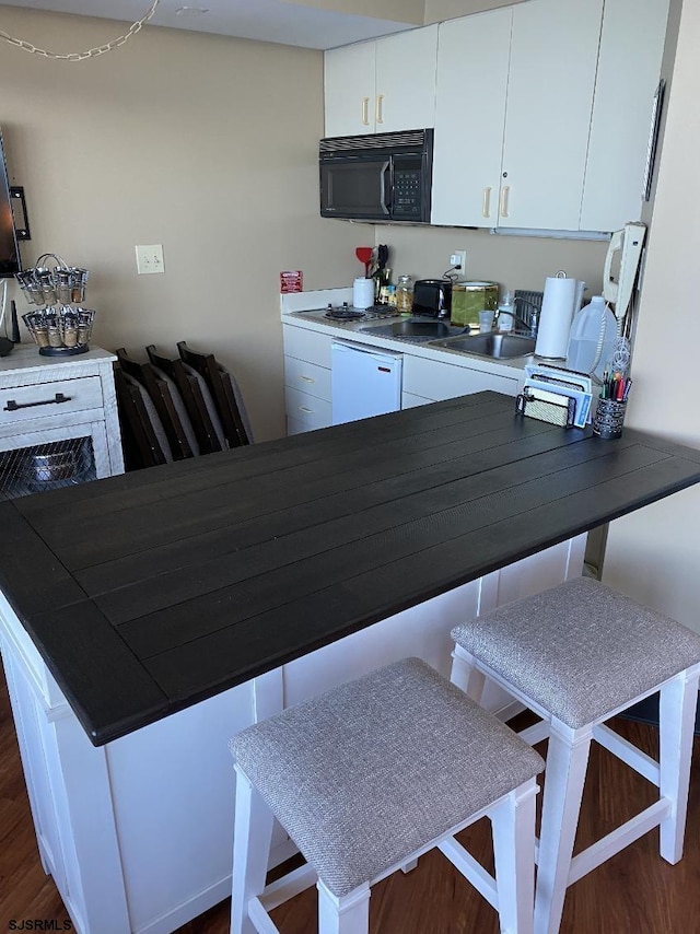1515 Boardwalk Unit 2805, Atlantic City, NJ 08401 - kitchen with black microwave, white cabinets, a sink, and dark countertops