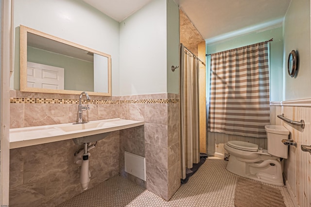 605 W Mill Rd, Northfield, NJ 08225 - bathroom featuring tile walls, toilet, a shower, tile patterned flooring, and wainscoting
