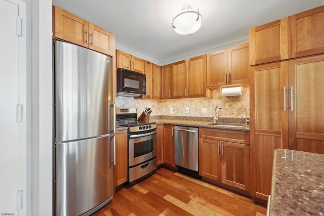 111 S 16th Ave Unit 605, Longport, NJ 08403 - kitchen featuring stainless steel appliances, wood finished floors, backsplash, and dark stone counters