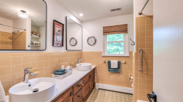 9 Lesley Ln, Northfield, NJ 08225 - full bathroom featuring baseboard heating, tile walls, a shower, double vanity, and a wainscoted wall