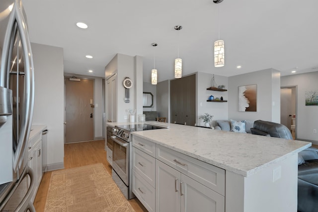 5000 Boardwalk Unit 1806, Ventnor, NJ 08406 - kitchen featuring appliances with stainless steel finishes, recessed lighting, white cabinets, open floor plan, and light stone countertops