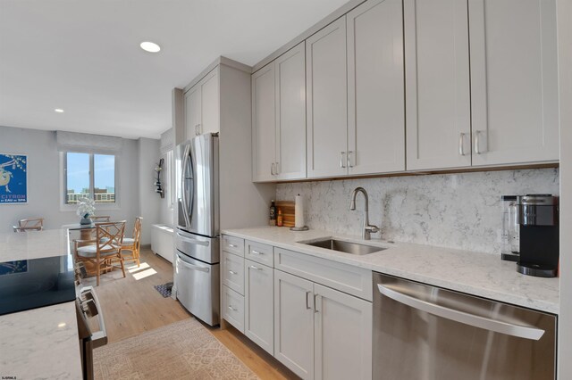 5000 Boardwalk Unit 1806, Ventnor, NJ 08406 - kitchen featuring appliances with stainless steel finishes, light wood-style flooring, backsplash, light stone countertops, and recessed lighting