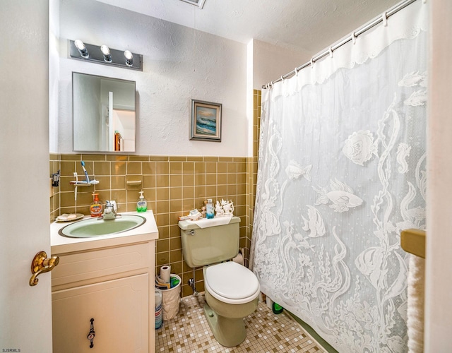 2137 Asbury Ave Unit 19, Ocean City, NJ 08226 - bathroom featuring vanity, tile patterned floors, tile walls, a shower with curtain, and a wainscoted wall
