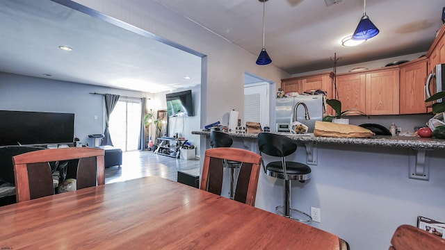 275 Heather Croft Unit 275, Egg Harbor Township, NJ 08234 - kitchen with stainless steel appliances, open floor plan, dark stone counters, a kitchen breakfast bar, and a peninsula