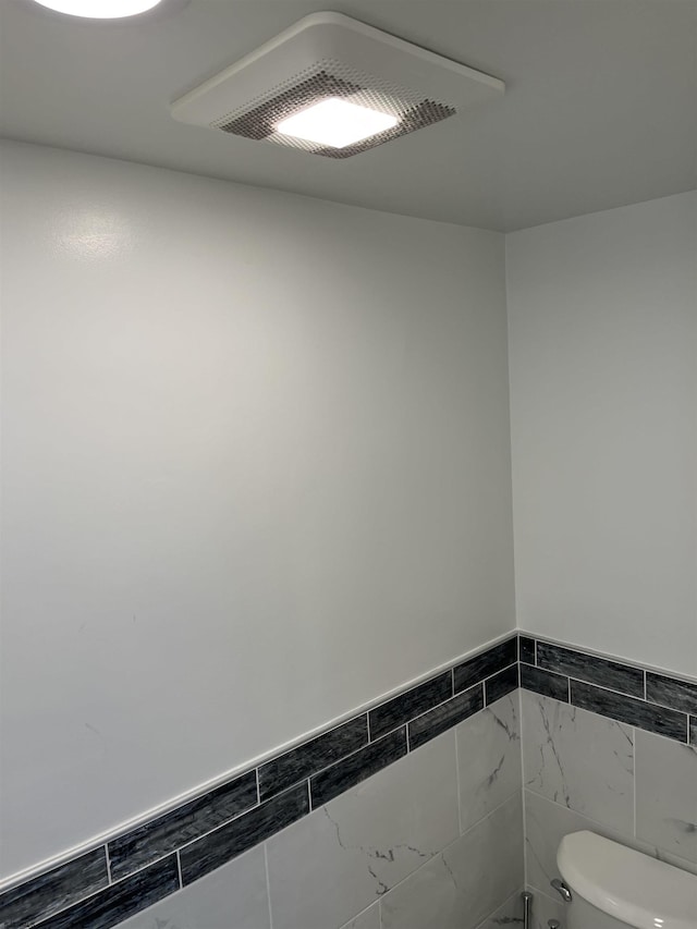 3101 Boardwalk Unit 2503-A Tower 1, Atlantic City, NJ 08401 - bathroom featuring tile walls and a wainscoted wall