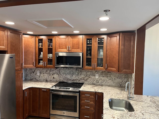 3101 Boardwalk Unit 2503-A Tower 1, Atlantic City, NJ 08401 - kitchen featuring stainless steel appliances, tasteful backsplash, light stone counters, recessed lighting, and glass insert cabinets