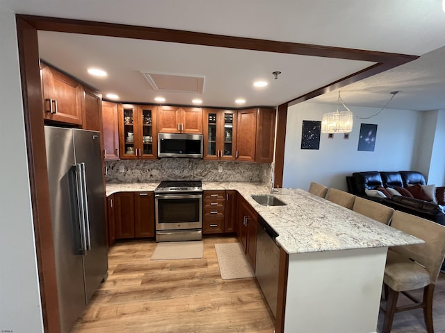 3101 Boardwalk Unit 2503-A Tower 1, Atlantic City, NJ 08401 - kitchen featuring stainless steel appliances, light wood-type flooring, a breakfast bar area, open floor plan, and light stone counters