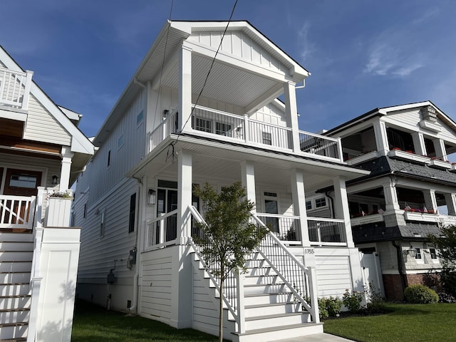 1755 Bay Ave, Ocean City, NJ 08226 - view of front facade featuring board and batten siding, stairway, a balcony, and covered porch