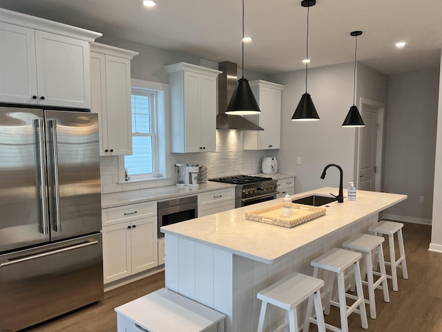 1755 Bay Ave, Ocean City, NJ 08226 - kitchen featuring premium appliances, wall chimney exhaust hood, an island with sink, decorative backsplash, and dark wood-style floors