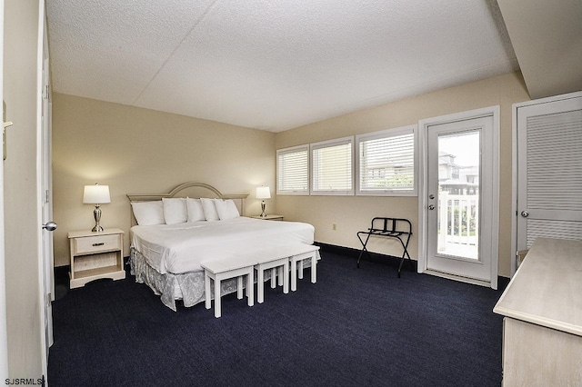 812 Ocean Ave Unit 112, Ocean City, NJ 08226 - bedroom with access to exterior, dark carpet, and a textured ceiling