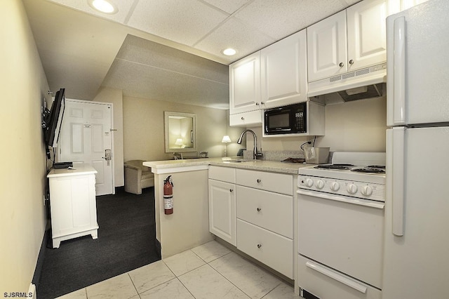 812 Ocean Ave Unit 112, Ocean City, NJ 08226 - kitchen featuring white appliances, under cabinet range hood, white cabinetry, light marble finish floors, and light countertops