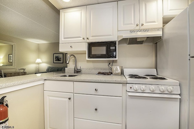 812 Ocean Ave Unit 112, Ocean City, NJ 08226 - kitchen with under cabinet range hood, white electric stove, black microwave, white cabinets, and light stone counters