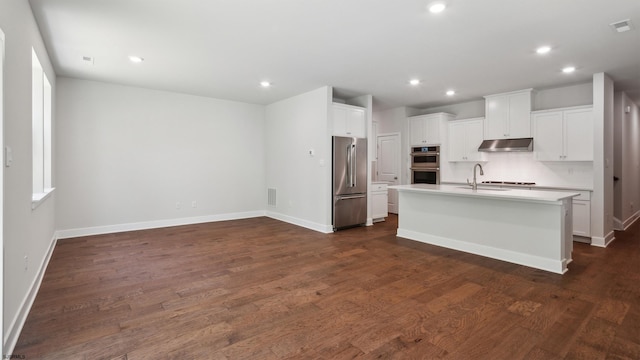 845 Broadway, West Cape May, NJ 08204 - kitchen featuring appliances with stainless steel finishes, under cabinet range hood, recessed lighting, an island with sink, and light countertops