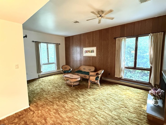 170 E Holly Ln Unit 170, Little Egg Harbor, NJ 08087 - sitting room featuring wood walls, carpet flooring, ceiling fan, and a baseboard radiator
