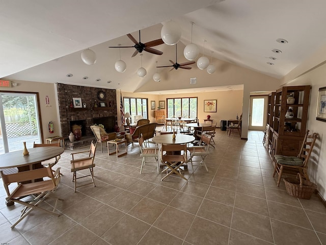 170 E Holly Ln Unit 170, Little Egg Harbor, NJ 08087 - dining area with dark tile patterned floors, a fireplace, high vaulted ceiling, and ceiling fan