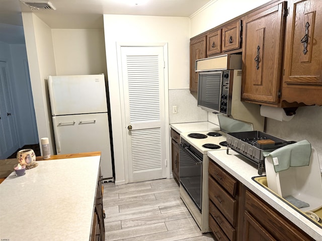 170 E Holly Ln Unit 170, Little Egg Harbor, NJ 08087 - kitchen with white appliances, light countertops, and light wood finished floors