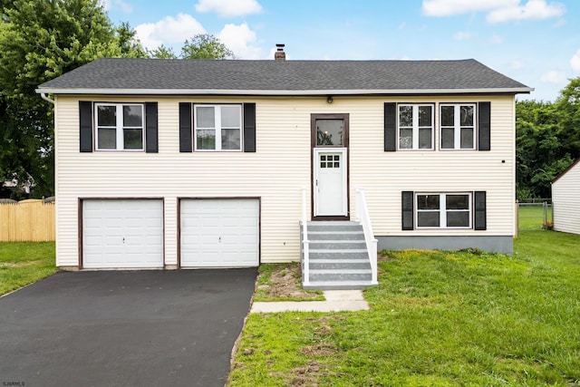 243 Wintergreen Ln, Penns Grove Borough, NJ 08069 - split foyer home featuring asphalt driveway, an attached garage, a chimney, and roof with shingles