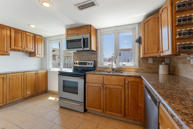 151 N Annapolis Ave Unit D, Atlantic City, NJ 08401 - kitchen featuring stainless steel appliances, tasteful backsplash, brown cabinetry, light tile patterned floors, and recessed lighting