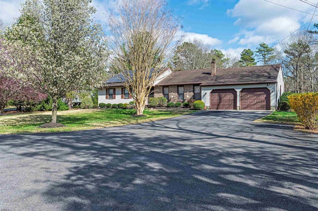 628 1st Ave, Galloway Township, NJ 08205 - view of front of property featuring driveway, a garage, a chimney, and a front yard