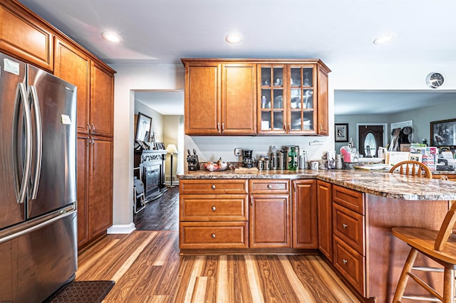 628 1st Ave, Galloway Township, NJ 08205 - kitchen with freestanding refrigerator, brown cabinets, a peninsula, glass insert cabinets, and recessed lighting