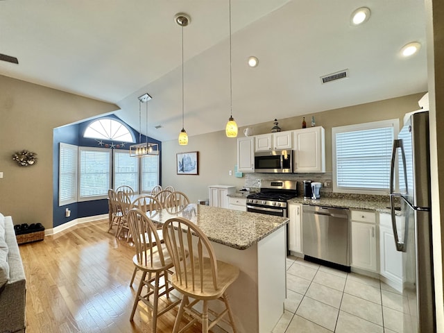 331 Asbury Ave Unit 2, Ocean City, NJ 08226 - kitchen featuring stainless steel appliances, healthy amount of natural light, vaulted ceiling, white cabinets, and recessed lighting