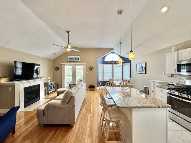 331 Asbury Ave Unit 2, Ocean City, NJ 08226 - kitchen featuring stainless steel appliances, lofted ceiling, white cabinetry, light wood-style flooring, and ceiling fan