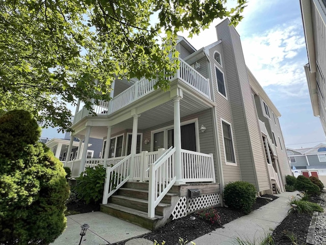 1611 Central Ave Unit 2, Ocean City, NJ 08226 - view of front of house with a balcony, a chimney, and a porch